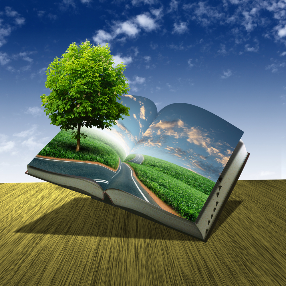 An open book with green natural landscape inside