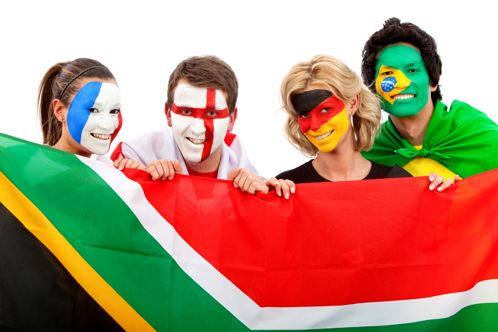 Group of football fans holding a southafrican flag with their faces painted isolated over white-1 Group of football fans holding a southafrican flag with their faces painted isolated over white-1